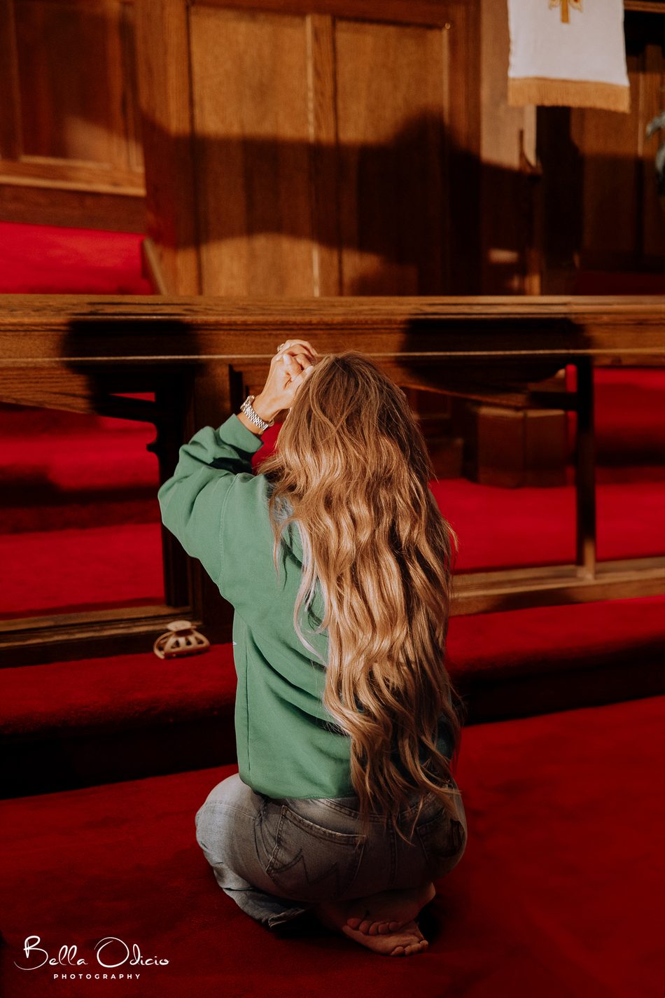 A woman kneeling in worship at the altar