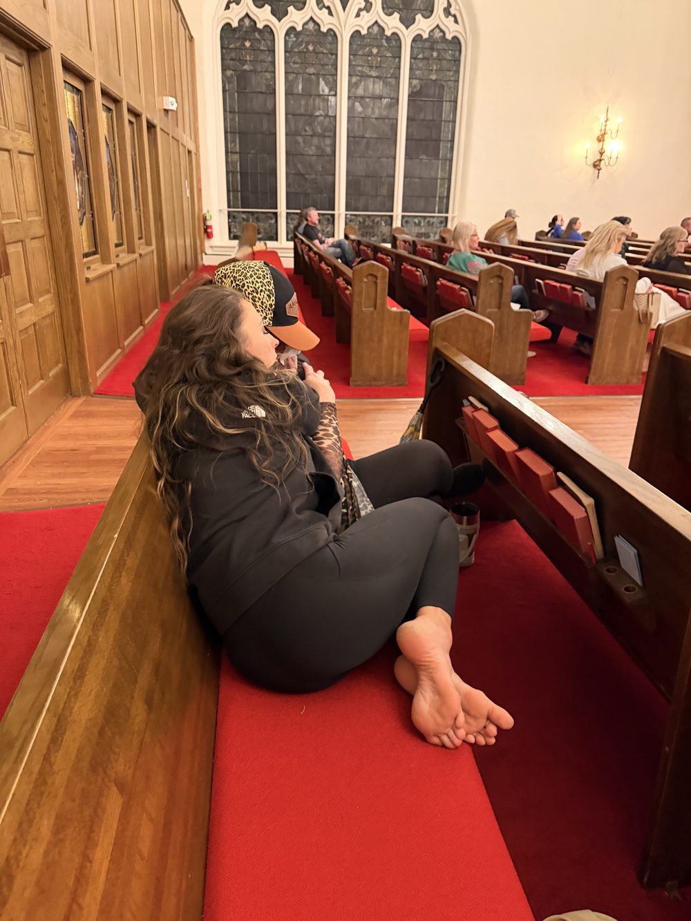 Women embracing in the pews at the Magdalene Crusade